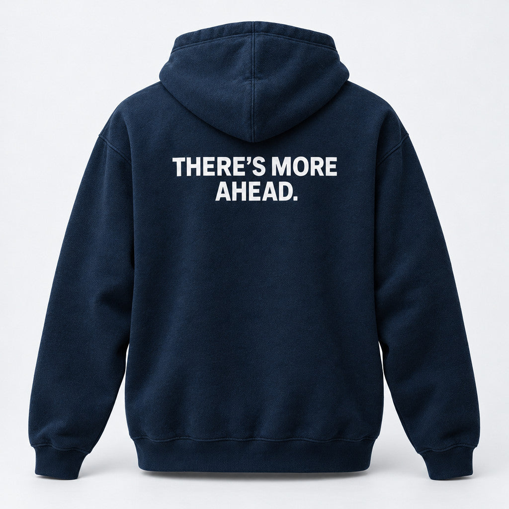 Generated product mockup of the midnight navy There’s More Ahead pullover hoodie, back view.