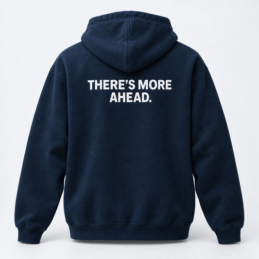 Generated product mockup of the midnight navy There’s More Ahead pullover hoodie, back view.
