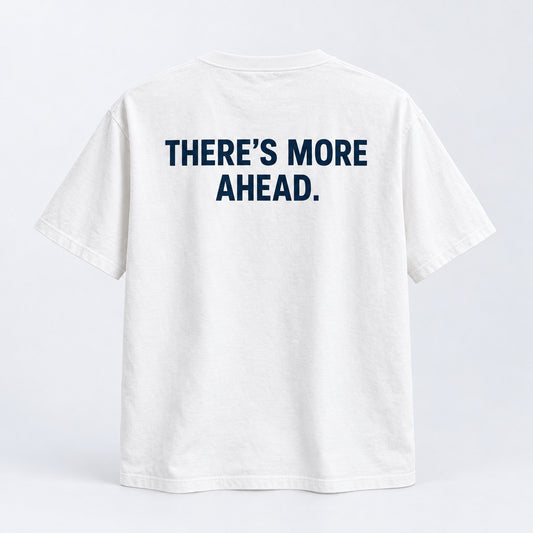 Generated product mockup of the white There’s More Ahead tee, back view.